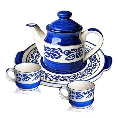 A hand-painted royal blue ceramic tea set with kettle, two mugs, and a serving tray.
